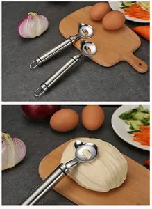 Close-up of stainless steel noodle slicer cutting dough on a wooden board.