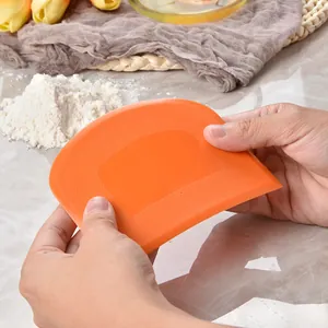 Professional orange plastic dough scraper and bench cutter for kitchen baking tasks