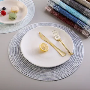 Nordic round heat-resistant placemat with blue and white cotton linen weave pattern.
