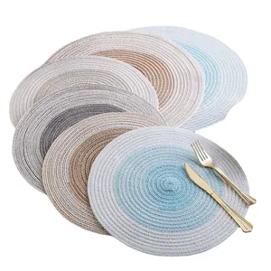 Set of Nordic style woven round heat-insulated placemats in multiple colors with cutlery