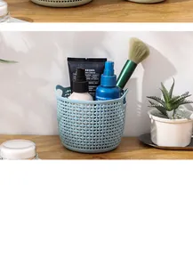 Close-up of a light blue hollow storage basket holding cosmetics on a wooden desk