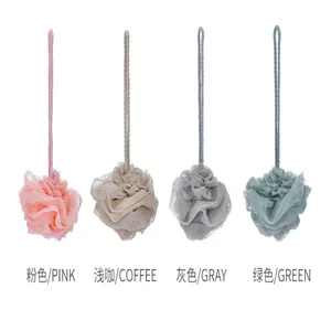 Detailed view of mesh shower puffs in pink, coffee, gray, and green colors with long loops
