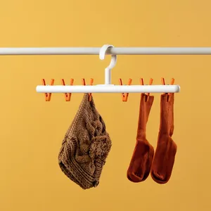 Durable white and orange plastic clothes hanger with clips for socks and underwear