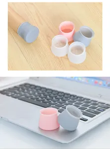 Close-up view of pink and grey silicone chair leg protectors for floor protection