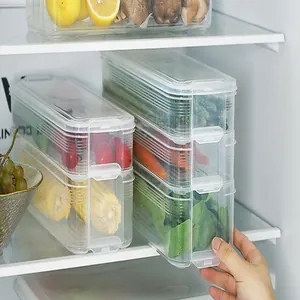 Close-up detail of transparent stackable plastic food storage containers inside a refrigerator.