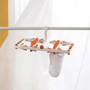Multifunctional plastic drying rack with orange clips for hanging socks and underwear clothes