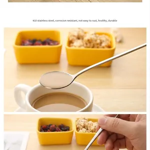 Detail of a 410 stainless steel long-handle coffee stirring spoon with warm lighting