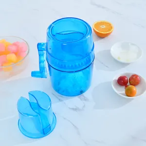 Manual blue ice shaver and crusher with hand crank for home use on marble background