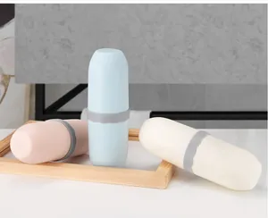 Set of three capsule-shaped travel toothbrush storage boxes in blue, pink, and cream