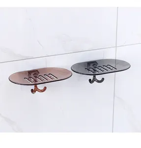 Two wall-mounted transparent soap dishes in amber and grey with drainage holes and hooks