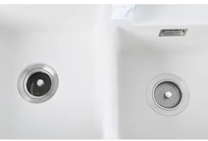 Draufsicht auf zwei Arten von Spülbecken-Sieben aus Edelstahl in einem weißen Waschbecken