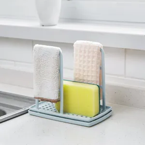Light blue kitchen sink organizer rack for drying sponges and dish cloths on countertop