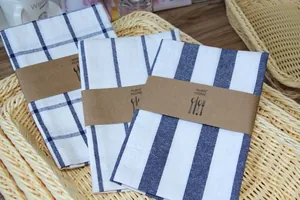 Detail view of Japanese linen napkins with navy blue stripes and grid patterns in a basket.