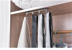 Close-up detail of silver under-shelf multi-hook rack organizing ties and clothes in a closet