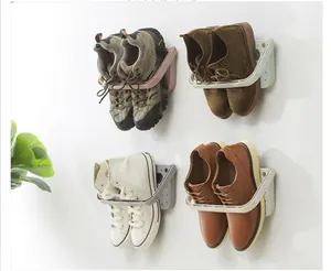 Wall-mounted folding shoe rack holders showing usage with different footwear