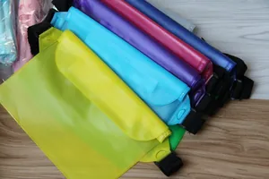 Detailed view of multiple colorful PVC waterproof waist bags for swimming and rafting activities