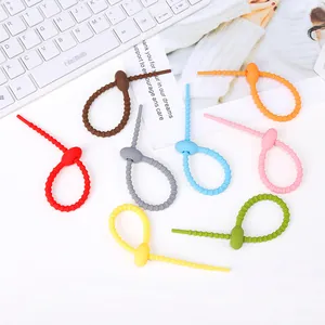 Colorful silicone cable ties and data cable organizer straps on white desk