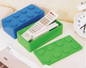 Close-up detail of stackable building block storage boxes used for organizing remotes