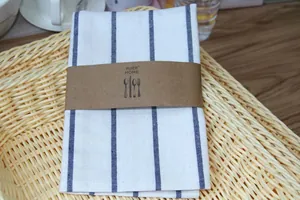 Detailed close-up view of a Japanese style linen striped napkin in a wicker basket.