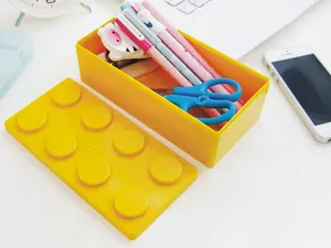 Yellow building block stackable storage box with lid showing interior stationery capacity