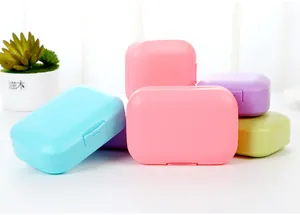 Multiple colorful portable travel soap containers with secure lids and drainage features