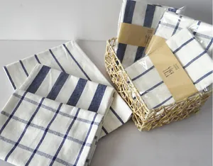 Detail of Japanese style linen napkins with blue striped and checkered patterns in a basket