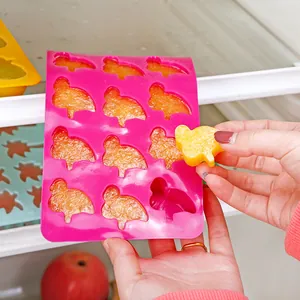 Pink duck-shaped silicone ice cube tray mold used for making frozen fruit snacks