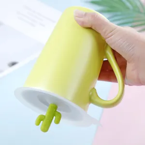 Vibrant green ceramic mug featuring a creative cactus shaped silicone dustproof lid