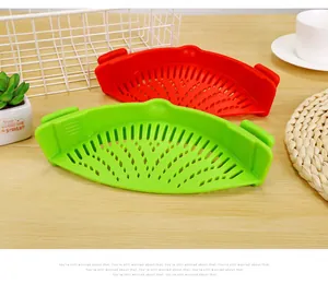 Macro view of red and green silicone clip-on pot strainers for easy kitchen drainage