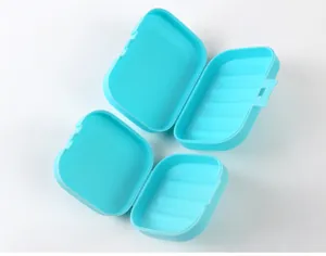 Detail view of two open turquoise portable soap boxes with internal drainage ridges
