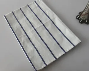 Detail shot of a Japanese style linen placemat with classic blue and white stripes