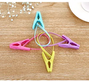Four colorful plastic clothespins with integrated hanging loops for drying socks