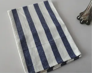 Close-up of Japanese style linen napkin with blue and white stripes on gray surface