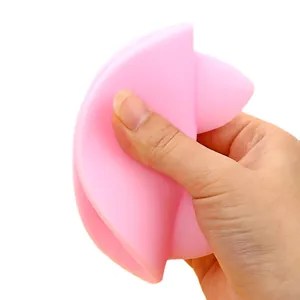 Flexible pink cat ear silicone cup lid demonstrating the soft and durable material texture