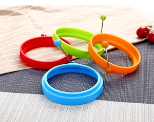 Close-up of colorful silicone egg rings featuring foldable stainless steel handles
