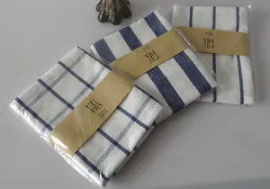 Detail view of Japanese style linen napkins with blue stripes and checks in paper packaging.