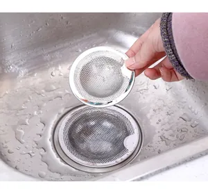 Detail showing a durable stainless steel sink strainer in a modern kitchen sink setting