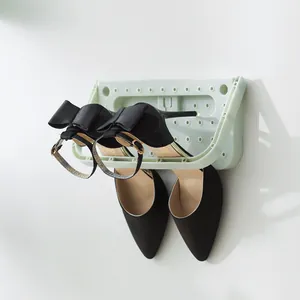 Space-saving foldable wall-mounted shoe rack in light green for bathroom storage