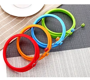 Colorful round silicone egg rings with heat-resistant handles for non-stick cooking