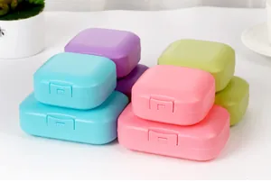 Detailed view of colorful portable travel soap boxes with secure lids and matte finish