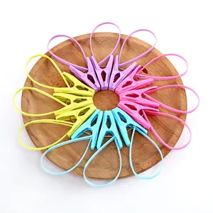 Colorful plastic clothespins with hanging loops for socks, arranged on a wooden plate.