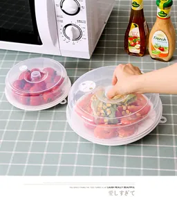Detail of translucent stackable microwave cover lid protecting shrimp and salad dishes