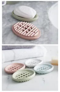 Silicone draining soap dishes in various pastel colors on a marble countertop detail