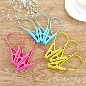 Set of colorful plastic clothes pegs with integrated hanging loops for laundry drying