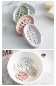 Set of colorful silicone soap dishes with drainage holes shown in a bathroom sink