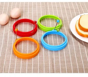 Set of colorful circular silicone egg rings with folding handles for fried eggs and pancakes.