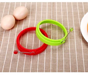 Set of two round silicone egg rings with handles shown on a checkered background