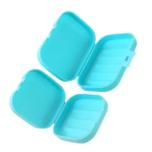 Two portable blue plastic soap boxes with lids and internal drainage for travel use