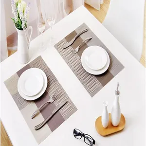 Detailed macro view of woven heat-resistant placemats on a white dining table