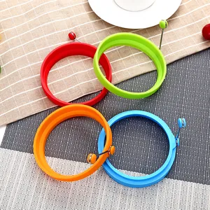 Set of 4 colorful round silicone egg rings with convenient handles for frying
